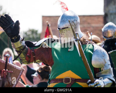 A Tudor knight in full armour carrying a poleaxe Stock Photo