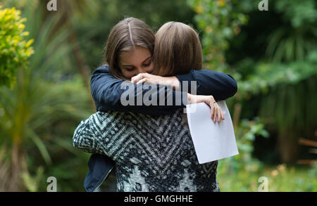 Two female girls celebrate their GCSE exam results at a school in Swansea, South Wales. Stock Photo