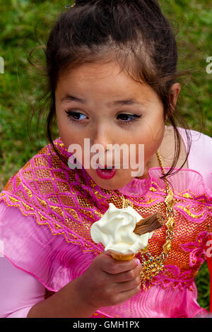 An Anglo Thai Child Eating An Ice Cream At The Brighton Thai Festival, Preston Park, Brighton, Sussex, UK Stock Photo