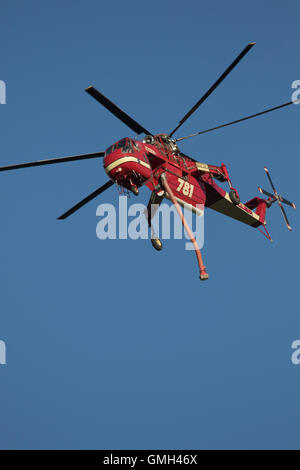 Water dropping firefighting helicopters in flight Stock Photo