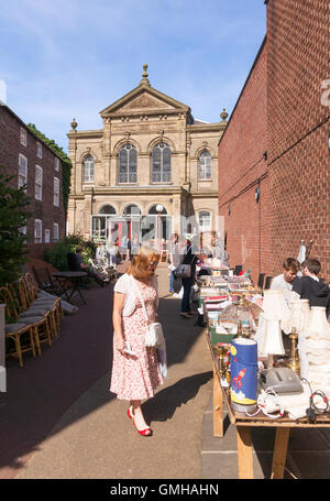 Woman looking at items for sale, jumble sale at the Wesley Chapel, Beverley, East Riding of Yorkshire, England, UK Stock Photo