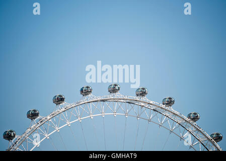 Horizontal close up of a portion of the London Eye with several capsules prominent against a bright blue sky. Stock Photo