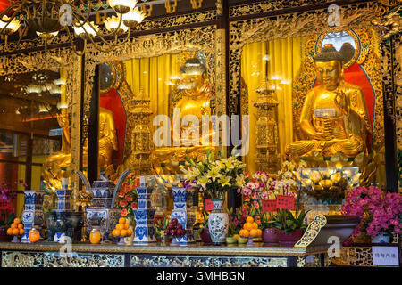 Buddha statues and altar at the Main Shrine Hall of Buddha at the Po Lin Monastery on Lantau Island in Hong Kong, China. Stock Photo