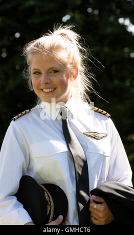 Portrait of a young blond female pilot in uniform Stock Photo