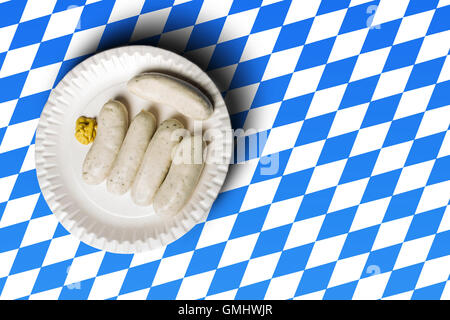 traditional bavarian sausages on white plate and bavarian flag Stock Photo