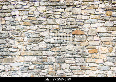 Close up of an ancient stone wall. Stone wall background. Stock Photo