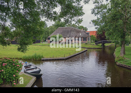 Giethoorn in The Netherlands is known for its bridges, waterways, thatched cottages  and punters and is also known as Dutch Venice Stock Photo