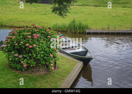 Giethoorn in The Netherlands is known for its bridges, waterways, thatched cottages  and punters and is also known as Dutch Venice Stock Photo