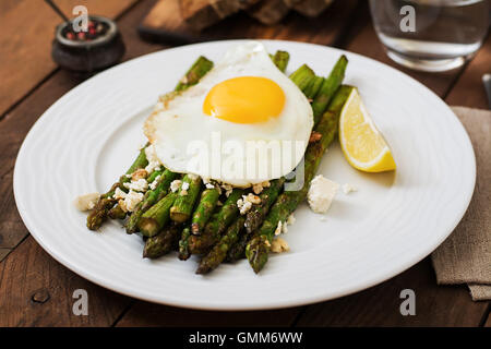 Warm salad of roasted asparagus, feta cheese and eggs Stock Photo