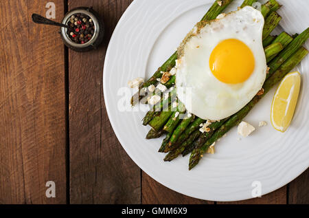 Warm salad of roasted asparagus, feta cheese and eggs. Top view Stock Photo