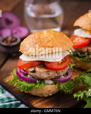 Hamburger (Sandwich) with chicken burger, lettuce, tomato, fried egg and tartar sauce Stock Photo