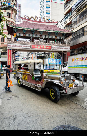 jeepney and busy street urban traffic in central manila city chinatown philippines Stock Photo