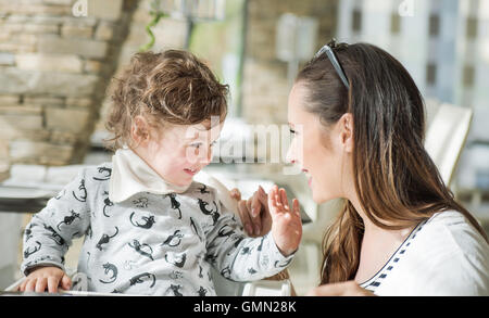 Happy mother and her little daughter having good time Stock Photo