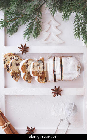 Christmas stollen dusted with icing sugar, partly sliced Stock Photo