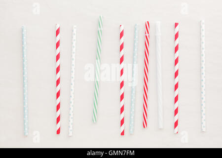 Drinking straws background. Set of different drinking straws over white background.  Top view, blank space Stock Photo