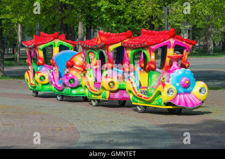 Cheerfully painted children's train for walks in the amusement park Stock Photo