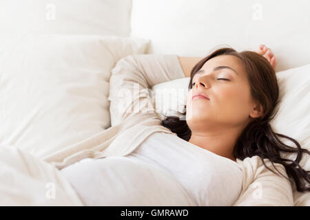 happy pregnant woman sleeping in bed at home Stock Photo