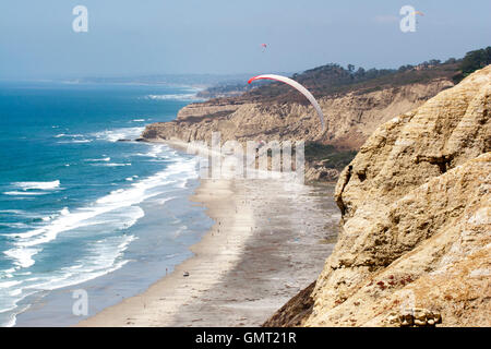 Person paragliding over beach in San Diego, California. Stock Photo
