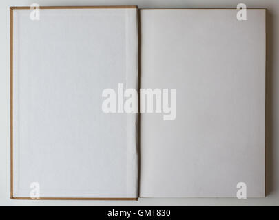 Old book opened to the first page showing blank pages inside. Stock Photo
