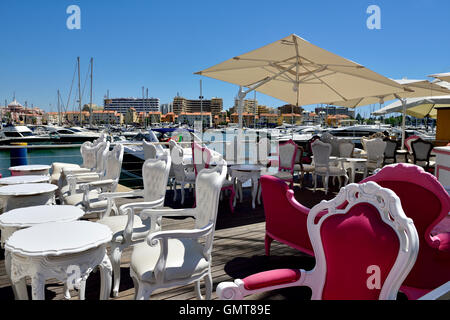 Restaurant along the quayside in Vilamoura harbour, near Quarteira and Faro Algarve, south Portugal Stock Photo