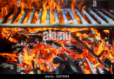 Glowing coals in a barbeque grill coal fire smoke Stock Photo