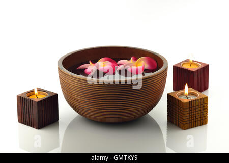 Wooden Spa Bowl With Candles and Floating Flowers Stock Photo