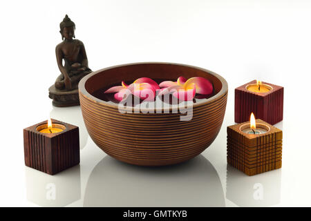 Wooden Spa Bowl With Buddha Statue ,Candles,and Floating Flowers Stock Photo