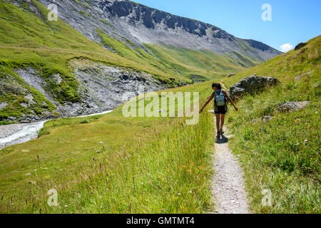 Woman touching the grass in the Valley Ferrand, Alps, Oisans, France, Europe. Stock Photo