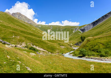 Family resting beside the Ferrand River in the Valley Ferrand, Oisans, France, Europe.