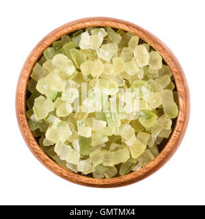 Diced green colored succade in a wooden bowl on white background. Candied peel of the citron fruit, Citrus medica. Stock Photo