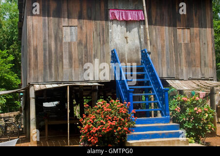 A typical middle class stilted wood house is well kept while standing in the morning sun in Chork village, Cambodia. Stock Photo