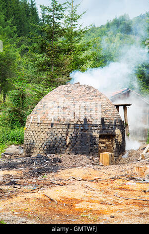 Traditional production of charcoal  in the forest in Serbia Stock Photo