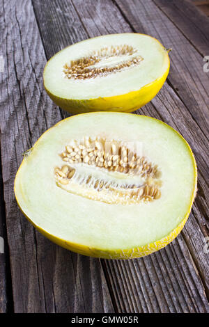 Slice of Cantaloupe melon on wooden background Stock Photo