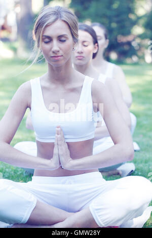 Beautiful woman sitting in Lotus pose, Padmasana, practicing yoga Stock ...
