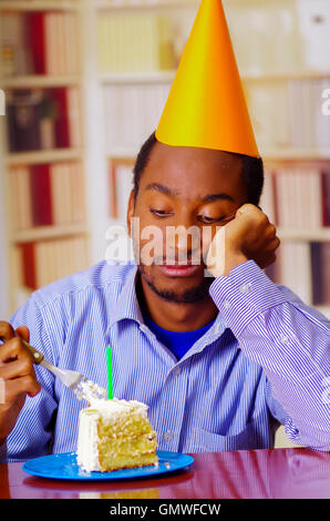 Young man with piece of birthday cake on beige background Stock Photo ...