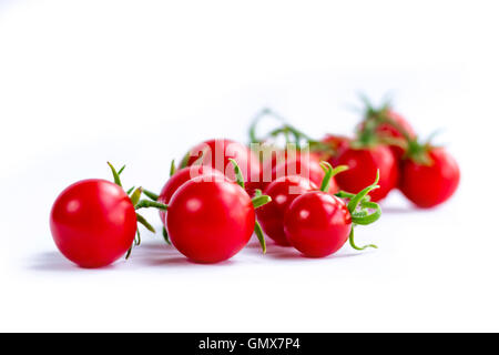 Cluster of cherry tomatoes on white background Stock Photo - Alamy