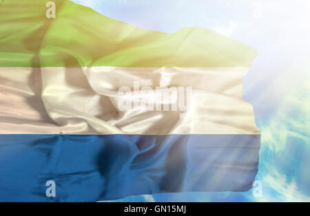Sierra Leone waving flag against blue sky Stock Photo - Alamy