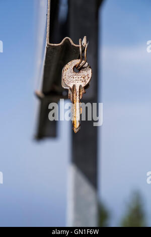 Pair of house keys found hanging from a roadsign, probably hung up by the finder in the hope that the loser will see them. Stock Photo