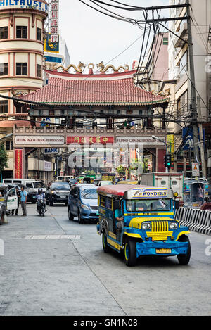 jeepney and busy street urban traffic in central manila city chinatown philippines Stock Photo