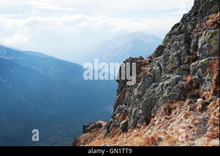 Rocky tip of the mountain with a vast valley in the background, Tatra Mountains, Poland Stock Photo