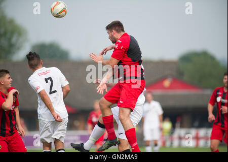 UK. 27th August, 2016. Evo-Stik Division 1 South and West; Winchester FC v Tiverton Town FC. Winchester City's H Neighbour winning an aerial duel. Credit:  Flashspix/Alamy Live News Stock Photo