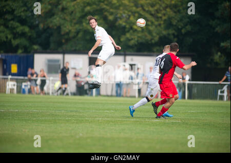 UK. 27th August, 2016. Evo-Stik Division 1 South and West; Winchester FC v Tiverton Town FC. Tiverton Town's Howe feeding Landricome with a knock on Credit:  Flashspix/Alamy Live News Stock Photo