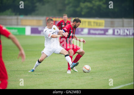 UK. 27th August, 2016. Evo-Stik Division 1 South and West; Winchester FC v Tiverton Town FC. Winchester's Jamie Brown guarding the ball with Landricome in close attendance. Credit:  Flashspix/Alamy Live News Stock Photo