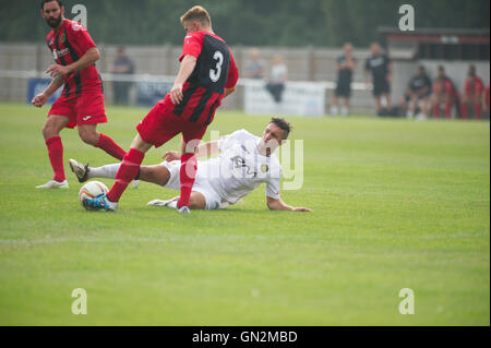 UK. 27th August, 2016. Evo-Stik Division 1 South and West; Winchester FC v Tiverton Town FC. Winchester's King slide tackled Credit:  Flashspix/Alamy Live News Stock Photo