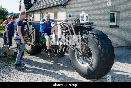 Rade, Germany. 27th Aug, 2016. Frank Dose for the first time on his built-bicycle, which he wants to set the Guinness Book record for 'the most heaviest wheeled bicycle in the world' in Rade, Germany, 27 August 2016. The vehicle currently weighs 940 kg on the scale but can potentially increase to around 1.2 tonnes. Photo: Markus Scholz/dpa/Alamy Live News Stock Photo