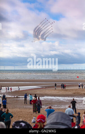 Rhyl, Denbighshire, Wales, UK. 28th August 2016. Rhyl Air Show – The annual air show at Rhyl seafront with the RAF Red Arrows. Spectators on the beach watch the Red Arrows fly by in formation Stock Photo