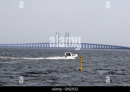 28 August  2016-Cargo ship passes by Oresunde link bridge international water between Denmark  and Denmark     Kastrup/Copenhagen / Denmark / Photo. Francis Joseph Dean/Deanpictures. Stock Photo