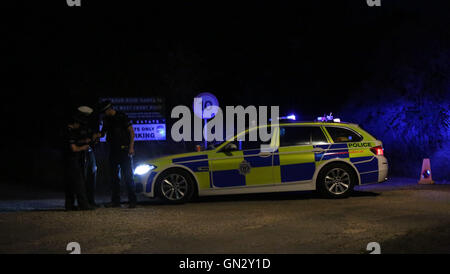 Pagham, West Sussex Sunday 28th August 2016. Emergency services were called to a property in Harbour Road, Pagham at around 4.10pm on Sunday (28 August) following reports a 72-year-old man was using threatening behaviour and armed with a gun. A woman known to the man was also in the house, but she has now left and is safe and well. There are no reported injuries. The 72-year-old man remains in the house alone. A police cordon has been set up around the house and the road has been closed. Officers, including firearms officers, remain at the scene while negotiations continue. © uknip/Alamy Live  Stock Photo