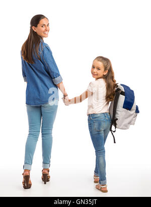 Mother and her little daughter walking together going to the school Stock Photo