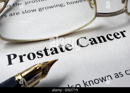 Page of hospital form with diagnosis prostate cancer and glasses. Stock Photo